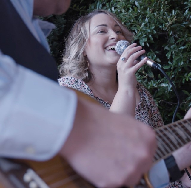 An image of Lux Bay acoustic duo playing live at a wedding breakfast. 